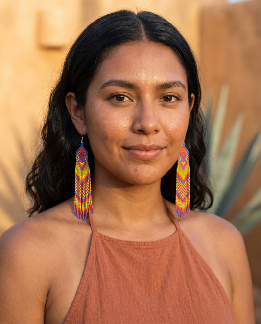 Sol & Stone Quetzal earrings, editorial portrait